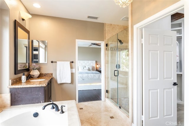 bathroom featuring walk in shower, vanity, ceiling fan, and tile patterned floors