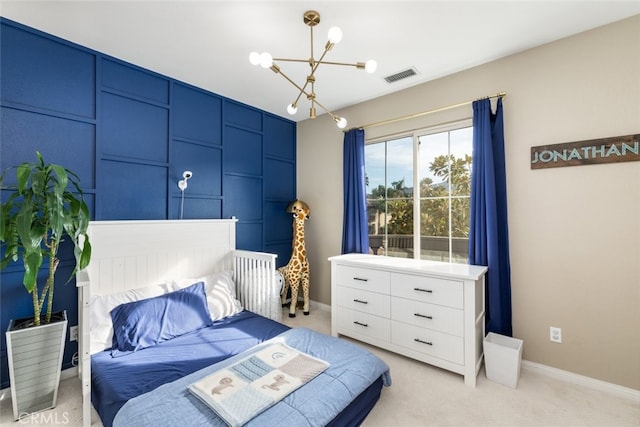 carpeted bedroom with a chandelier