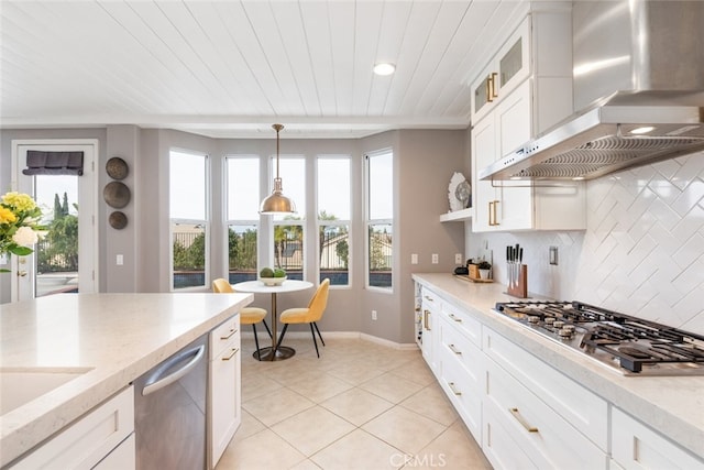 kitchen with stainless steel appliances, white cabinetry, decorative light fixtures, and wall chimney range hood