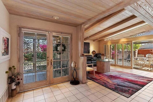 interior space with light tile patterned flooring, french doors, vaulted ceiling with beams, and wood ceiling