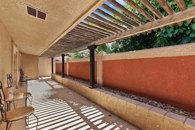 balcony featuring a patio and a pergola