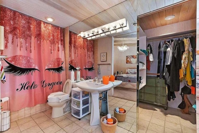 bathroom with toilet and tile patterned flooring