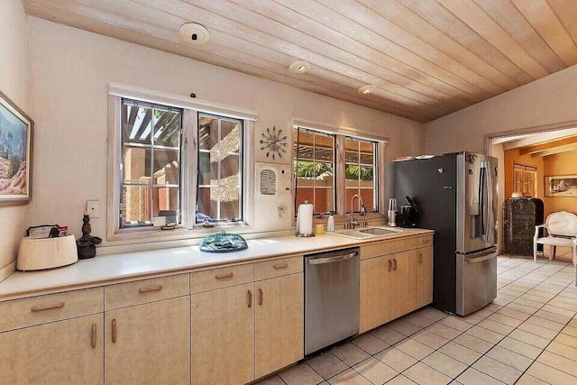 kitchen featuring vaulted ceiling, appliances with stainless steel finishes, sink, light tile patterned floors, and wooden ceiling