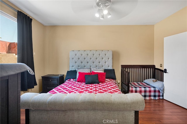 bedroom featuring dark hardwood / wood-style floors and ceiling fan