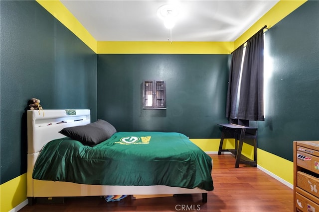 bedroom with wood-type flooring