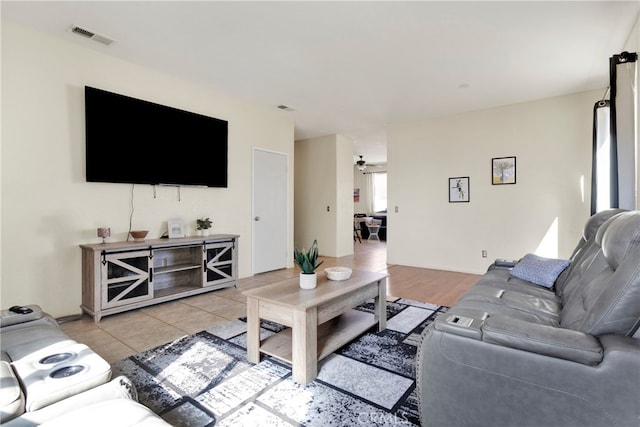 living room featuring ceiling fan and light tile patterned floors