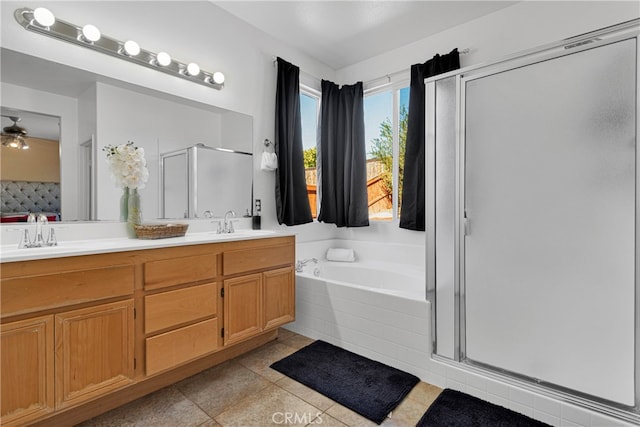 bathroom with vanity, shower with separate bathtub, ceiling fan, and tile patterned flooring