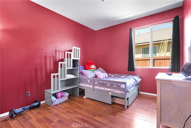 bedroom with dark hardwood / wood-style floors