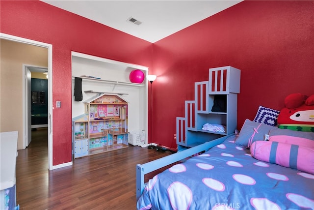 bedroom with dark hardwood / wood-style flooring