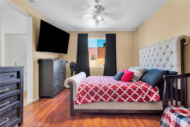 bedroom with hardwood / wood-style floors and ceiling fan