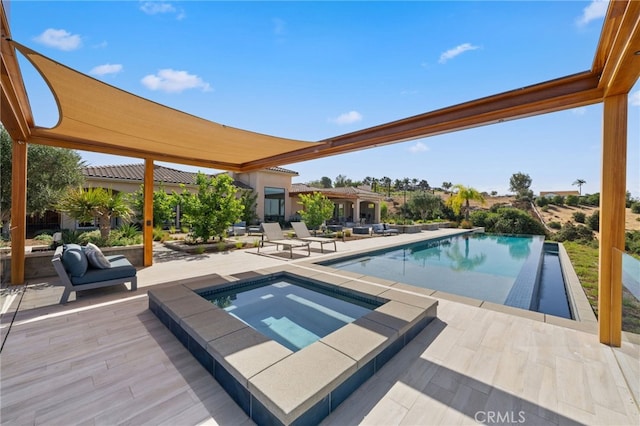 view of pool with a patio and an in ground hot tub