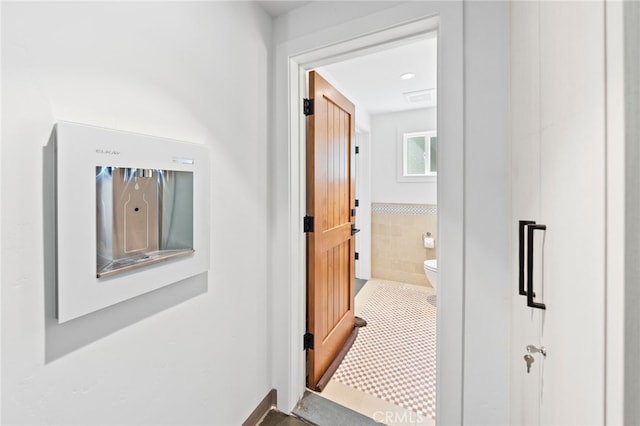 hall featuring tile patterned flooring