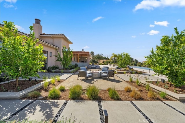 exterior space featuring a patio area and outdoor lounge area