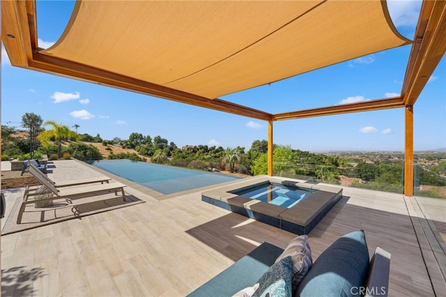 view of pool with a patio area and an in ground hot tub