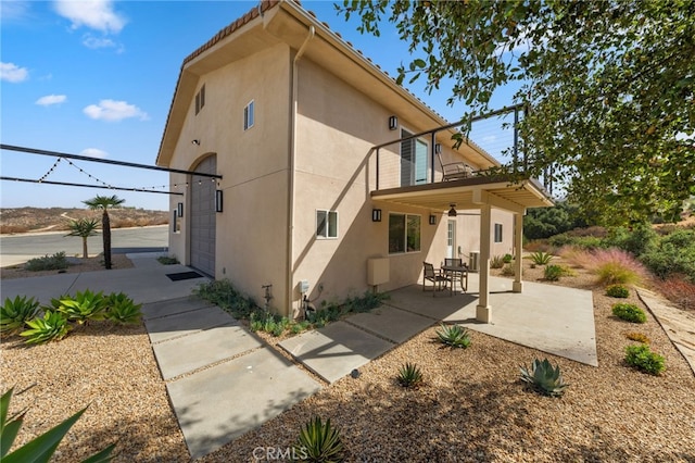 back of property with a patio