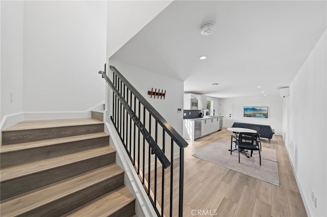 stairway featuring hardwood / wood-style floors