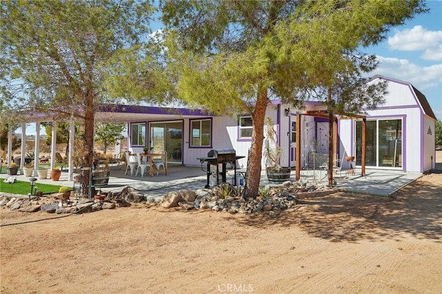 rear view of property featuring a patio