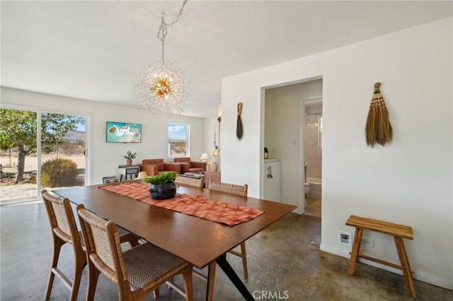 dining space featuring a chandelier and a healthy amount of sunlight