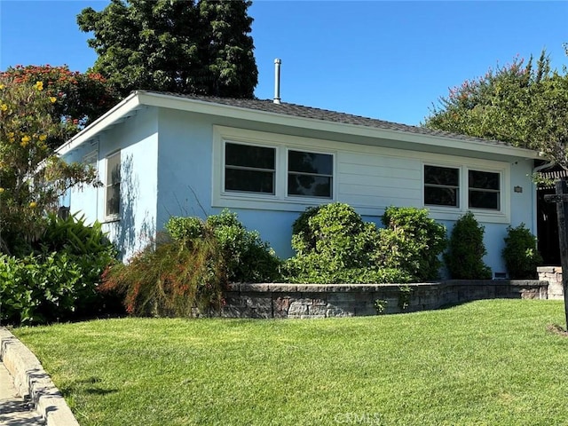 view of side of home featuring a lawn