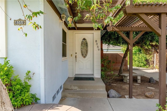 property entrance with a pergola