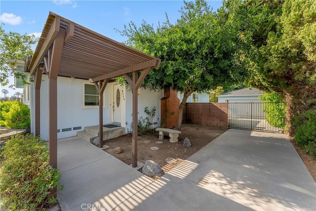 view of patio / terrace with a garage and an outdoor structure