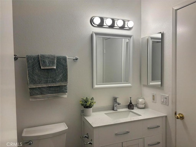 bathroom with toilet and vanity