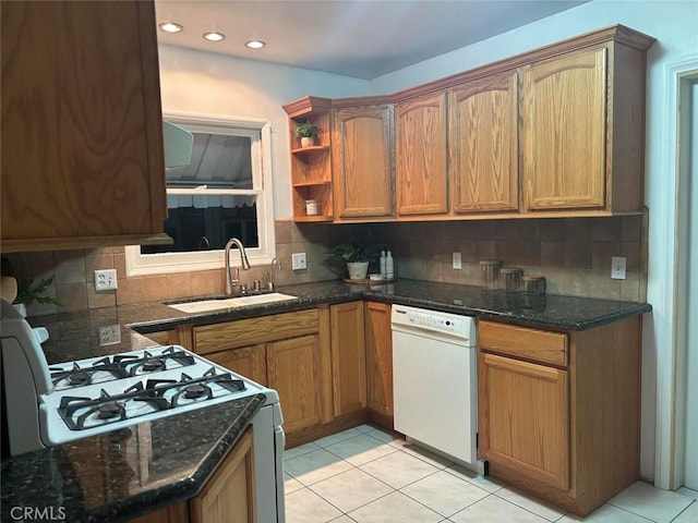 kitchen featuring light tile patterned floors, sink, tasteful backsplash, and white appliances