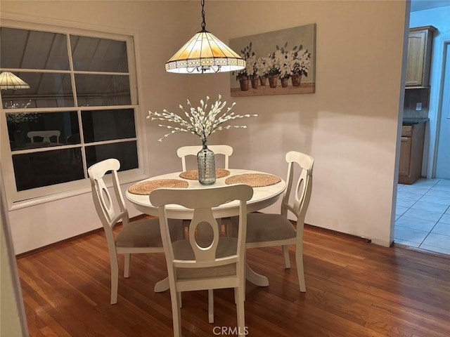 dining area with dark hardwood / wood-style floors