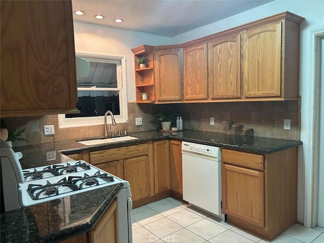 kitchen with light tile patterned floors, sink, tasteful backsplash, and white appliances