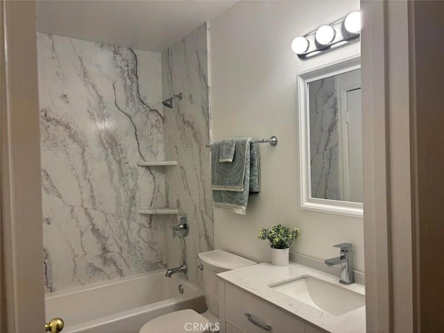 full bathroom featuring toilet, tiled shower / bath, and vanity