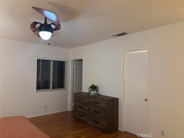 bedroom with dark wood-type flooring