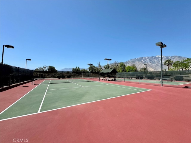 view of sport court featuring basketball court and a mountain view