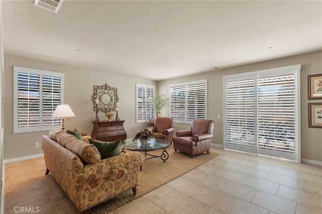 living room featuring light tile patterned flooring and plenty of natural light