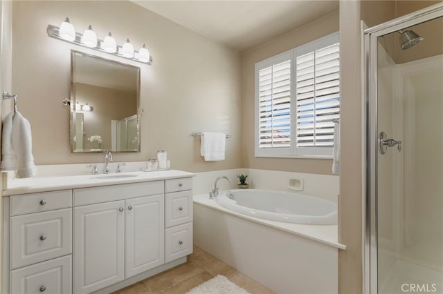 bathroom with tile patterned flooring, independent shower and bath, and vanity