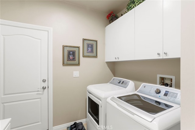 washroom featuring washer and dryer and cabinets