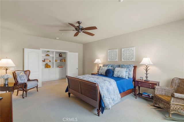 bedroom with light carpet and ceiling fan