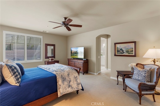 carpeted bedroom with ceiling fan and connected bathroom