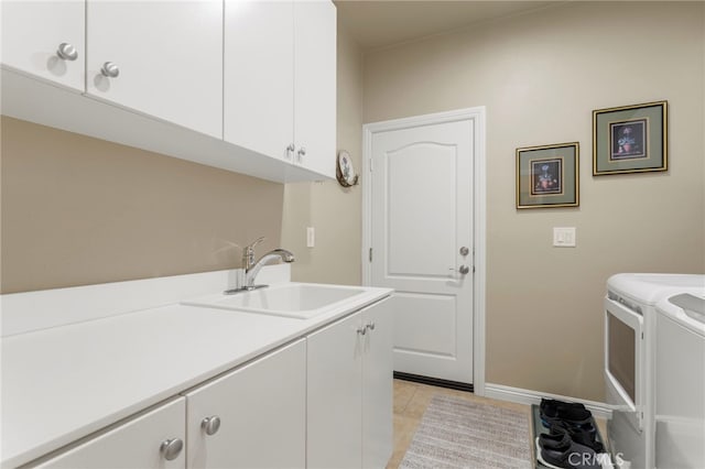 laundry area with sink, washing machine and dryer, light tile patterned flooring, and cabinets