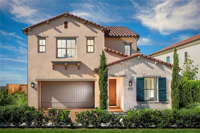 mediterranean / spanish-style home featuring a garage