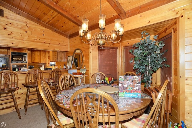 carpeted dining room with wood walls, lofted ceiling with beams, a chandelier, and wooden ceiling