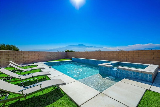 view of swimming pool featuring an in ground hot tub