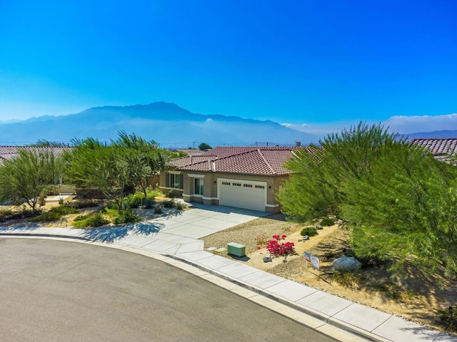 view of front of property featuring a garage and a mountain view