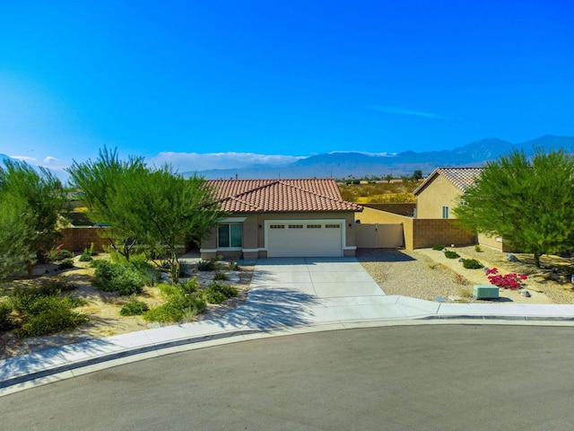 view of front of home with a garage and a mountain view