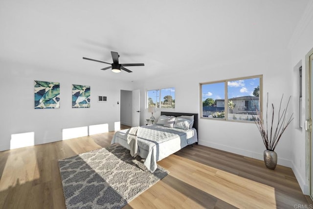 bedroom with wood-type flooring and ceiling fan