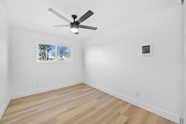 unfurnished room featuring ceiling fan, light wood-type flooring, and ornamental molding