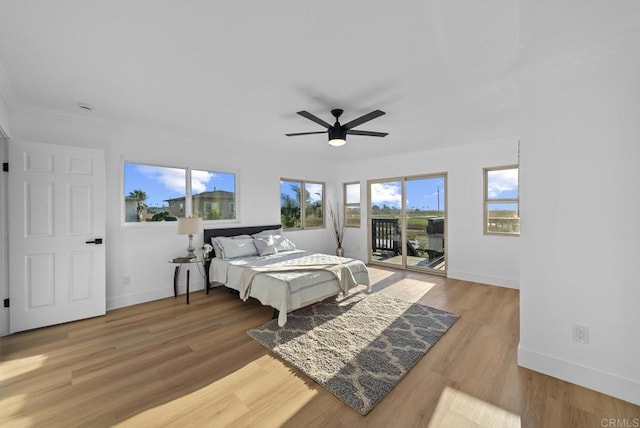 bedroom with wood-type flooring, access to outside, and ceiling fan