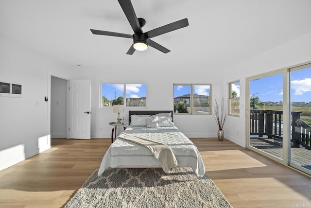 bedroom featuring ceiling fan, light hardwood / wood-style floors, and access to exterior