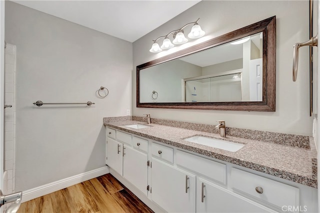 bathroom featuring vanity, wood-type flooring, and walk in shower