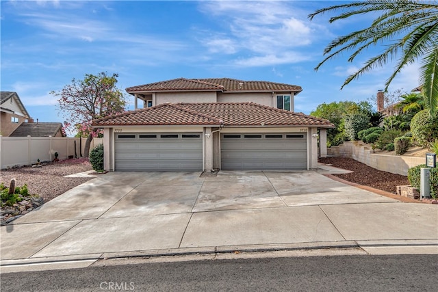 mediterranean / spanish-style home with a garage