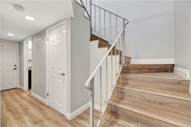 stairway featuring hardwood / wood-style floors